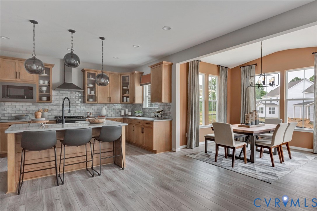 925 Charlemagne Road Midlothian, VA 23114 - Photo 1 of 43 a dining room with stainless steel appliances granite countertop a kitchen island a stove and a wooden floors