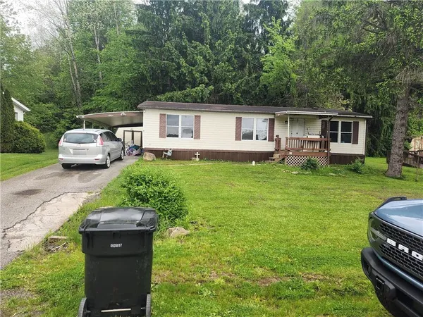 a house view with a sitting space and garden
