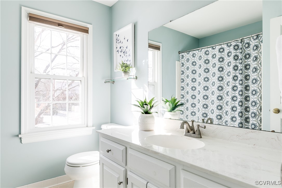 5300 Krag Road Chester, VA 23831 - Photo 19 of 33 a bathroom with a granite countertop sink a toilet and a large mirror