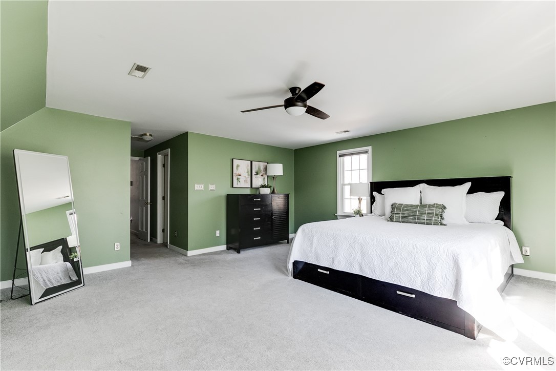 5300 Krag Road Chester, VA 23831 - Photo 27 of 33 a spacious bedroom with a bed and a chandelier