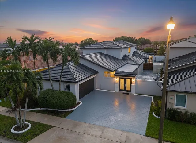 a view of a house with backyard and a patio