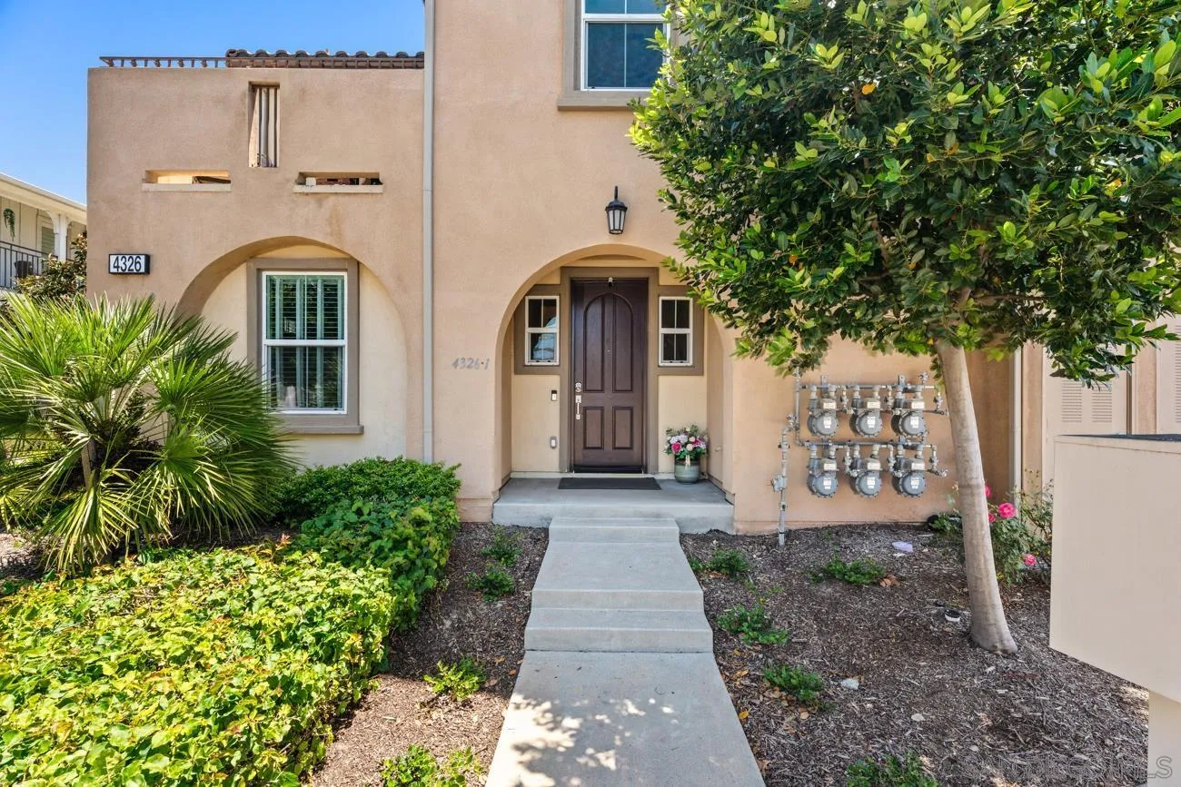 4326 Star Path Way, Unit 1 Oceanside, CA 92056 - Photo 4 of 46 a front view of a house with garden