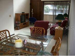 705 Southwest 75th Street Gainesville, FL 32607 - Photo 1 of 1 a living room with furniture and a window