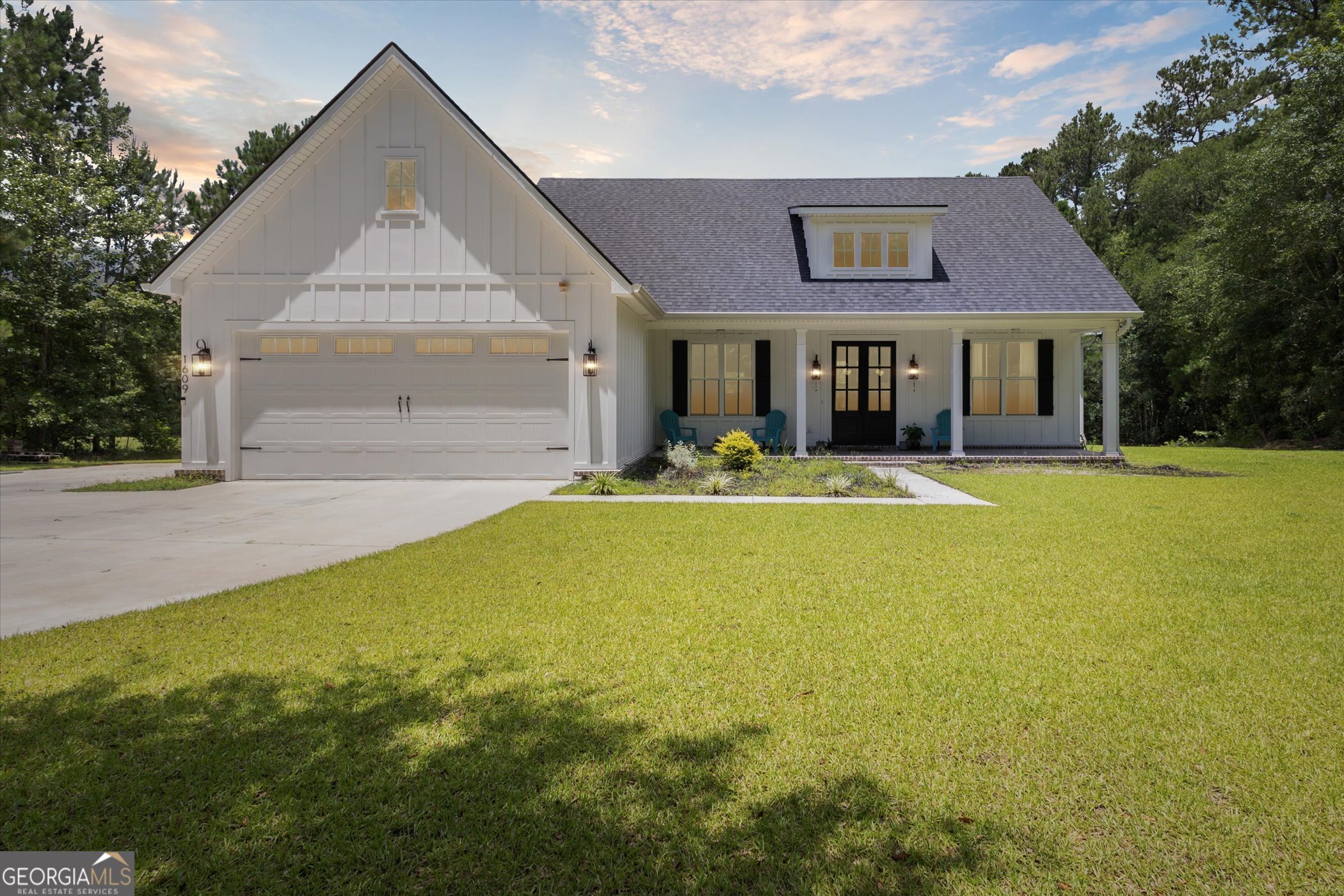 1609 Lee Road Pembroke, GA 31321 - Photo 1 of 1 a front view of a house with a yard and trees