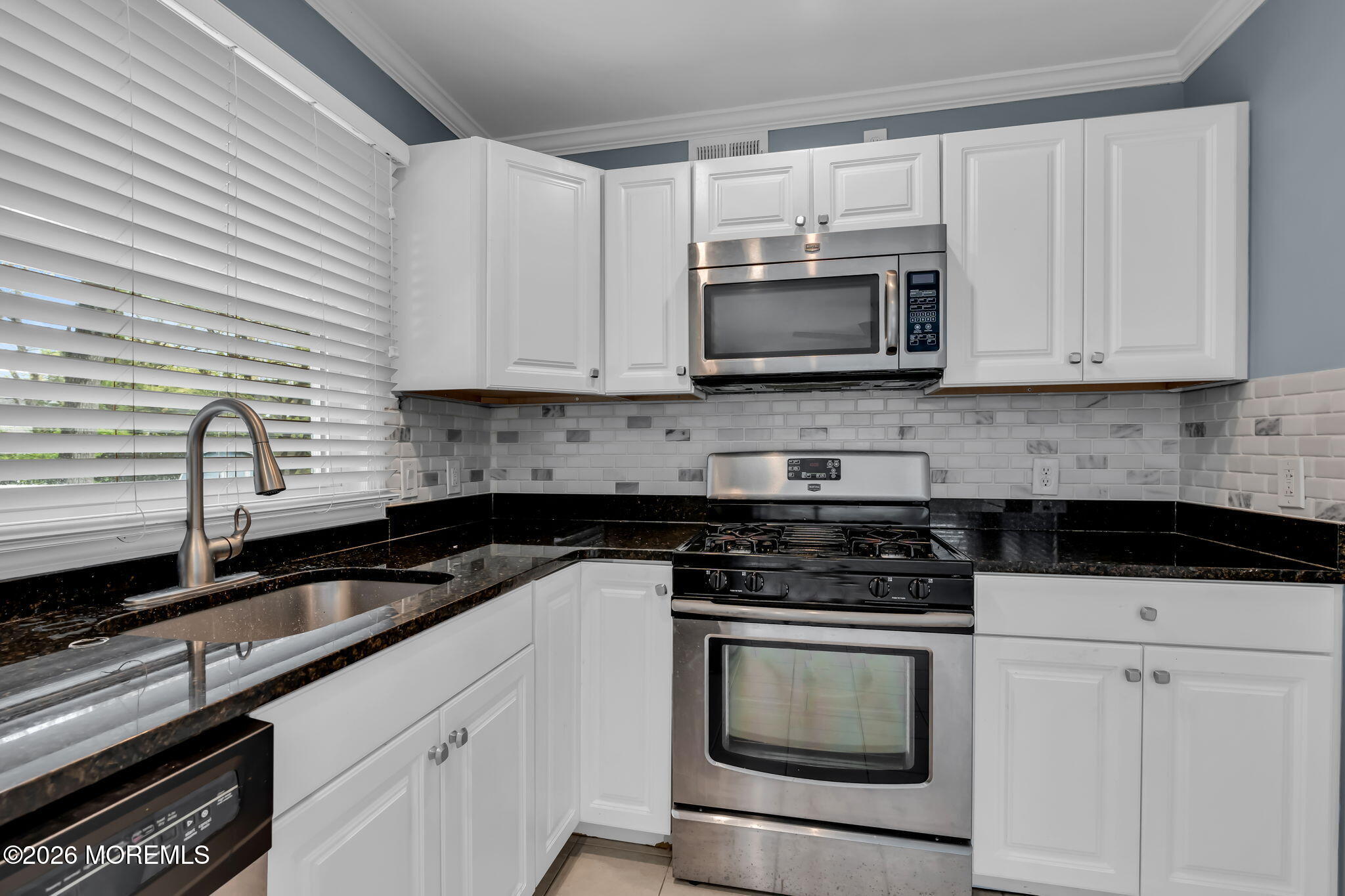 593 Beach Plum Road Brick, NJ 08723 - Photo 14 of 38 a kitchen with granite countertop white cabinets and stainless steel appliances