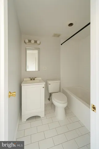 a white toilet sitting next to a bathroom sink