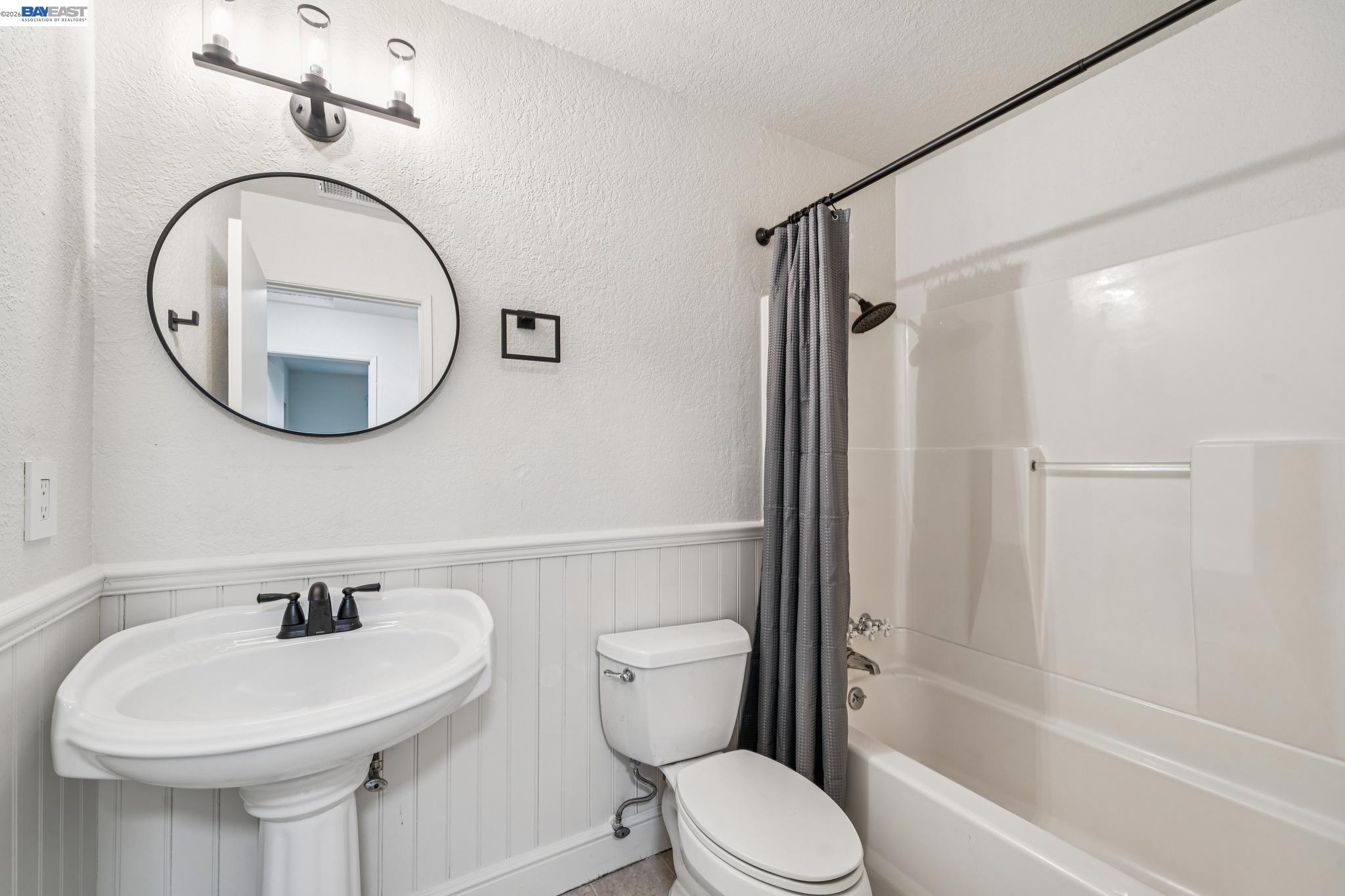 554 Chestnut Avenue Tracy, CA 95376 - Photo 17 of 27 a bathroom with a sink a toilet and a mirror