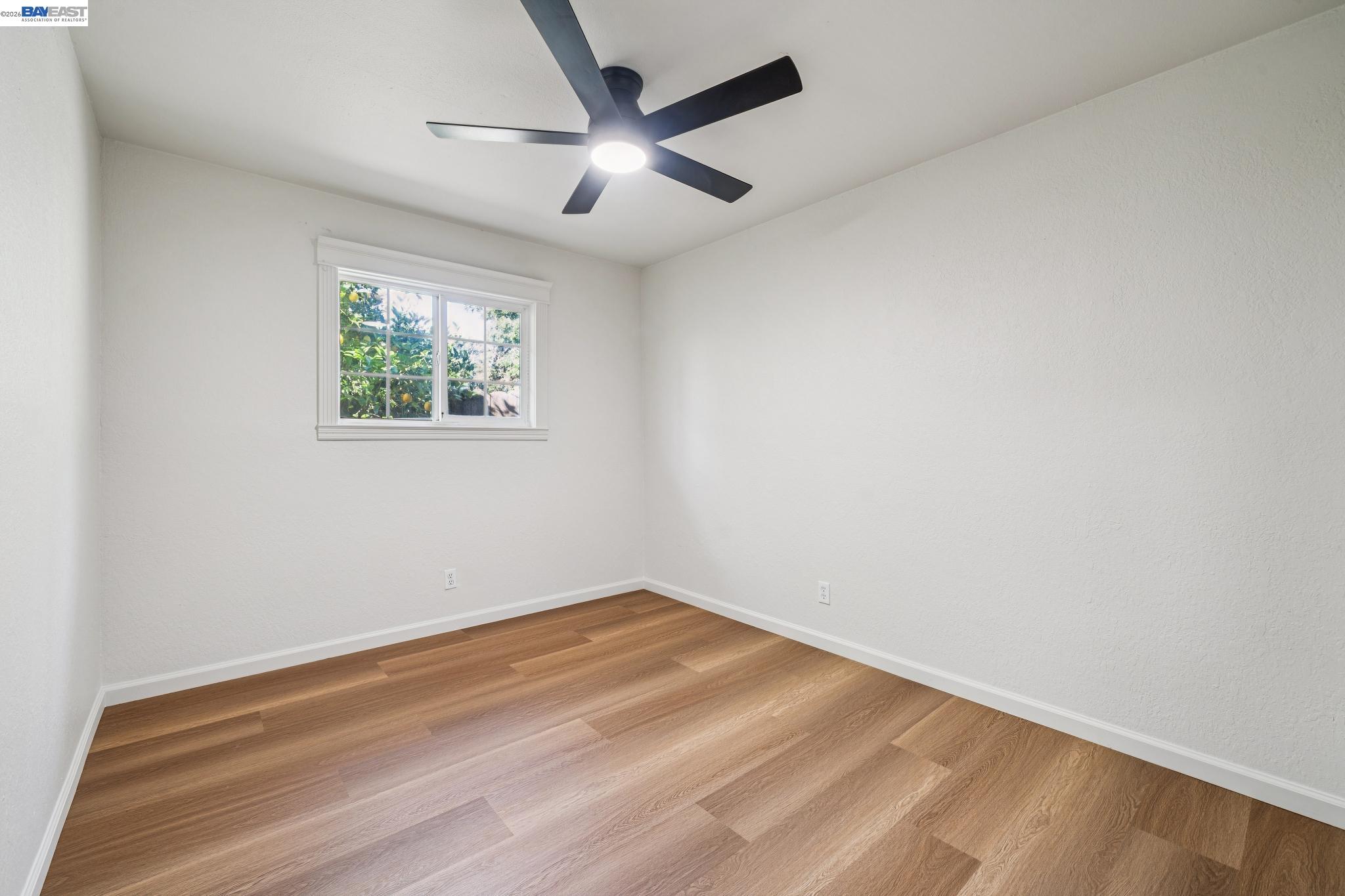 554 Chestnut Avenue Tracy, CA 95376 - Photo 18 of 27 an empty room with wooden floor and ceiling fan