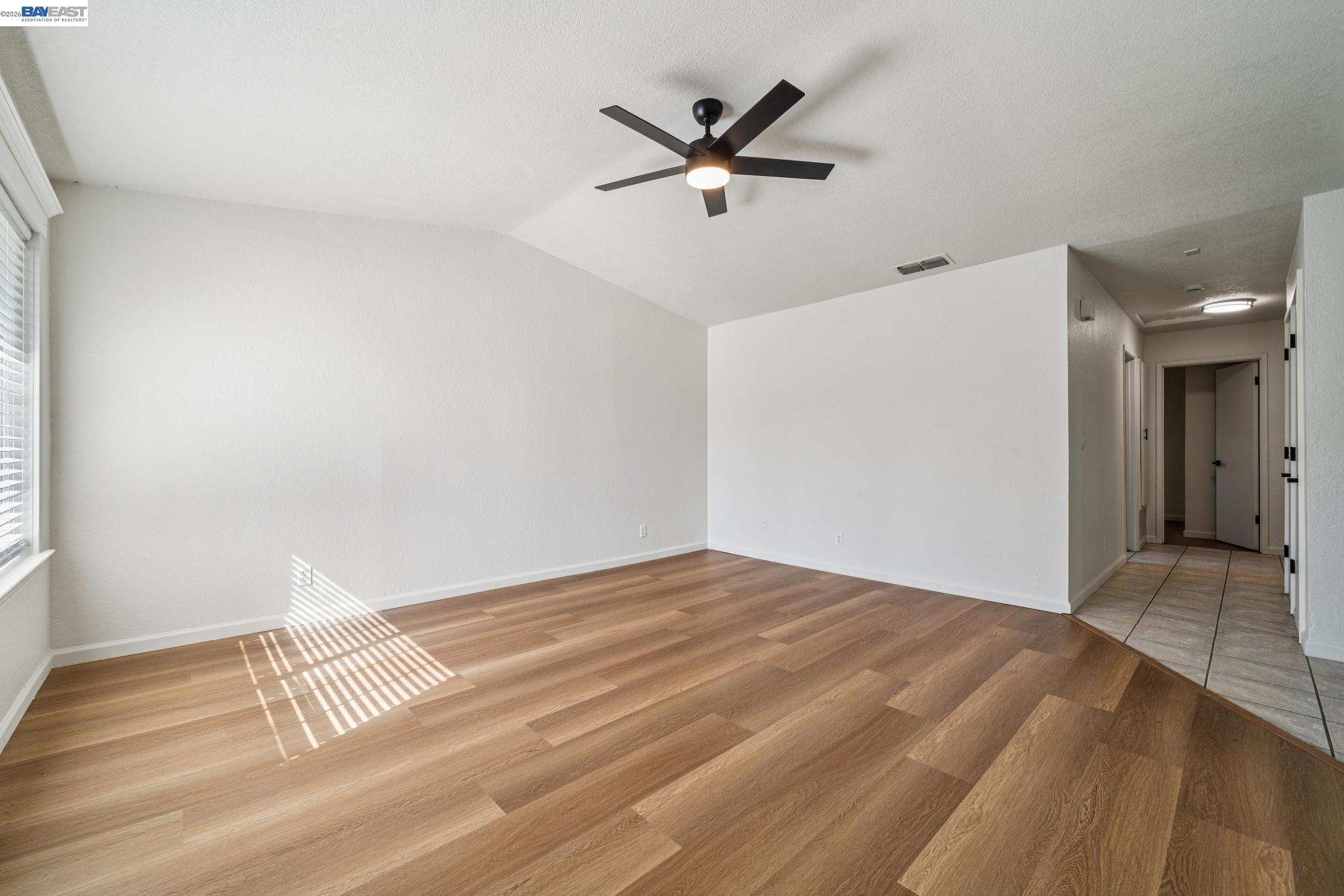 554 Chestnut Avenue Tracy, CA 95376 - Photo 2 of 27 a view of a livingroom with a ceiling fan and wooden floor