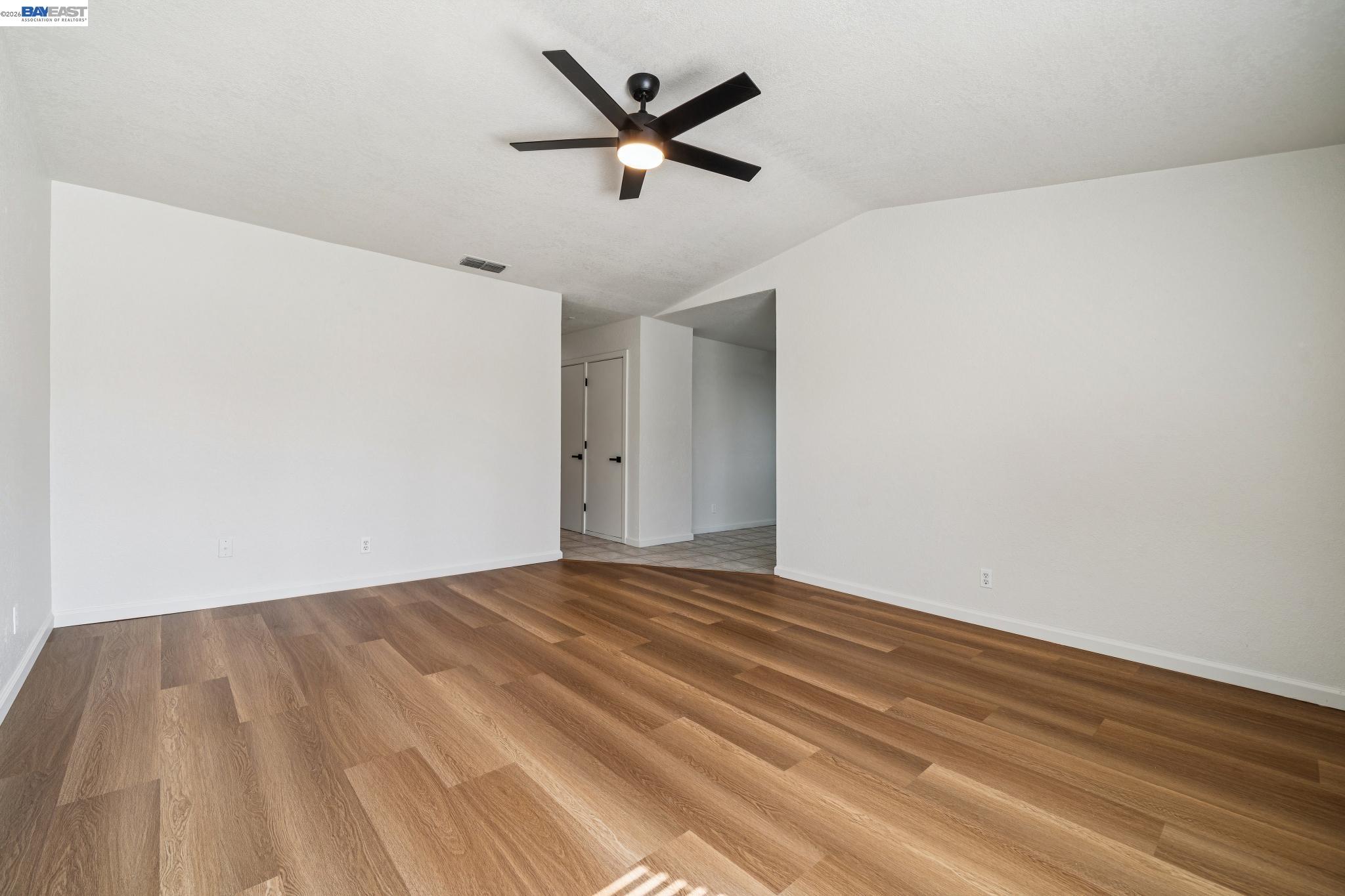 554 Chestnut Avenue Tracy, CA 95376 - Photo 4 of 27 a view of a room with wooden floor and a ceiling fan