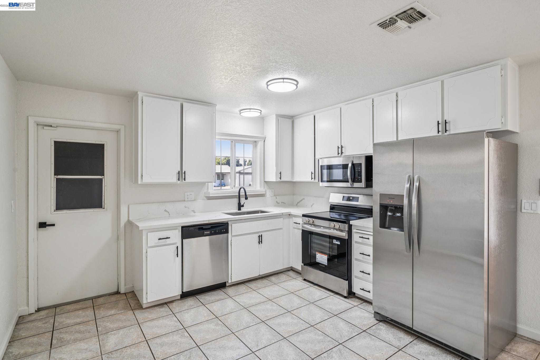 554 Chestnut Avenue Tracy, CA 95376 - Photo 7 of 27 a kitchen with stainless steel appliances granite countertop a refrigerator and a sink