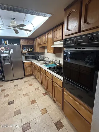 a kitchen that has a lot of cabinets in it