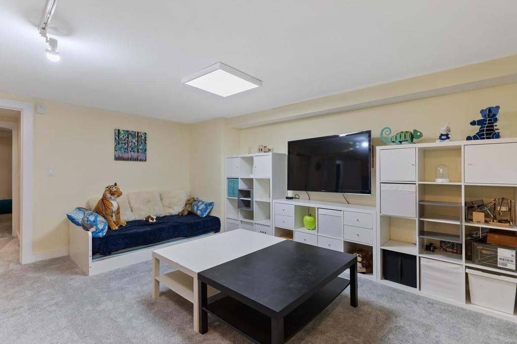 20 Ledgewood Road Weston, MA 02493 - Photo 25 of 34 a living room with furniture and a flat screen tv