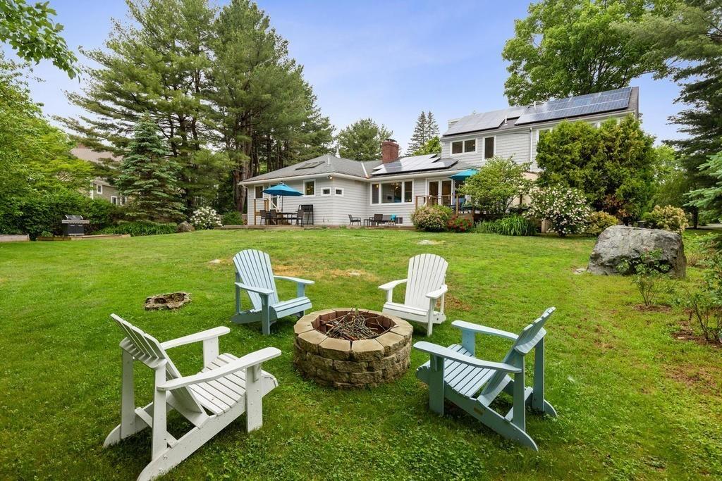 20 Ledgewood Road Weston, MA 02493 - Photo 31 of 34 a view of a chairs and table in backyard of the house