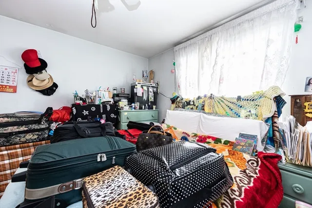 a living room with furniture a air conditioner and a window