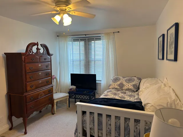 a bedroom with a bed and a tv