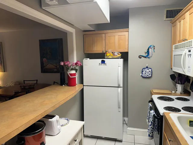 a white refrigerator freezer sitting inside of a kitchen