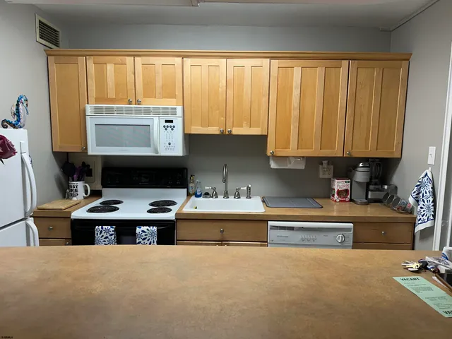 a kitchen with stainless steel appliances a stove a sink and a microwave