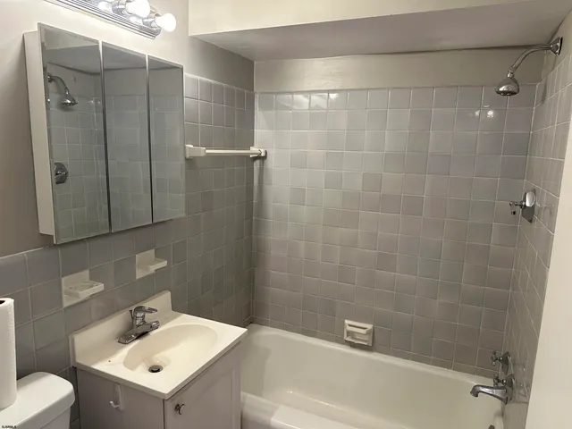 a bathroom with a sink mirror and shower