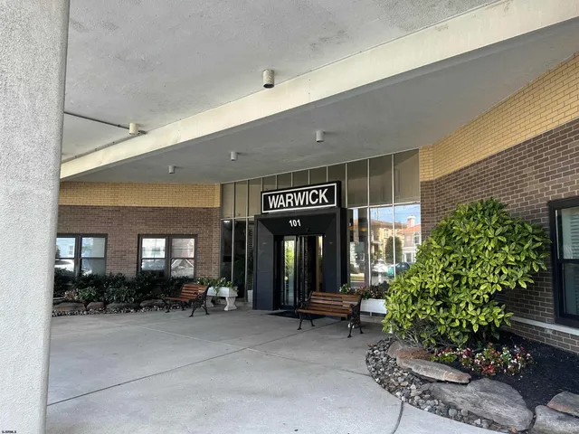 a view of a building with potted plants