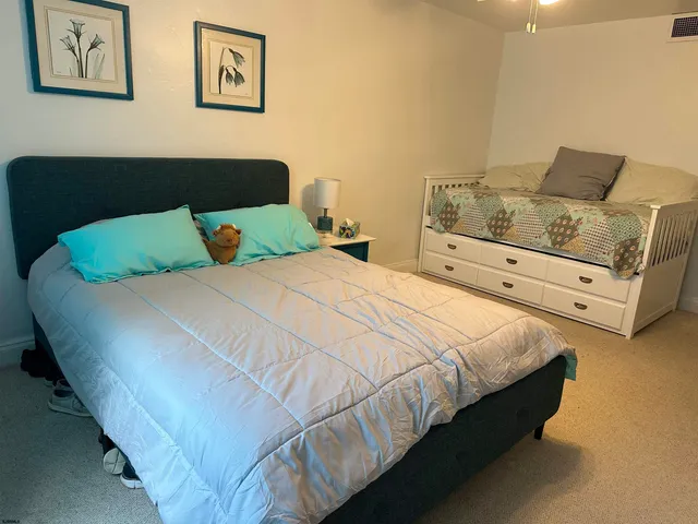 a bedroom with bed and cupboard