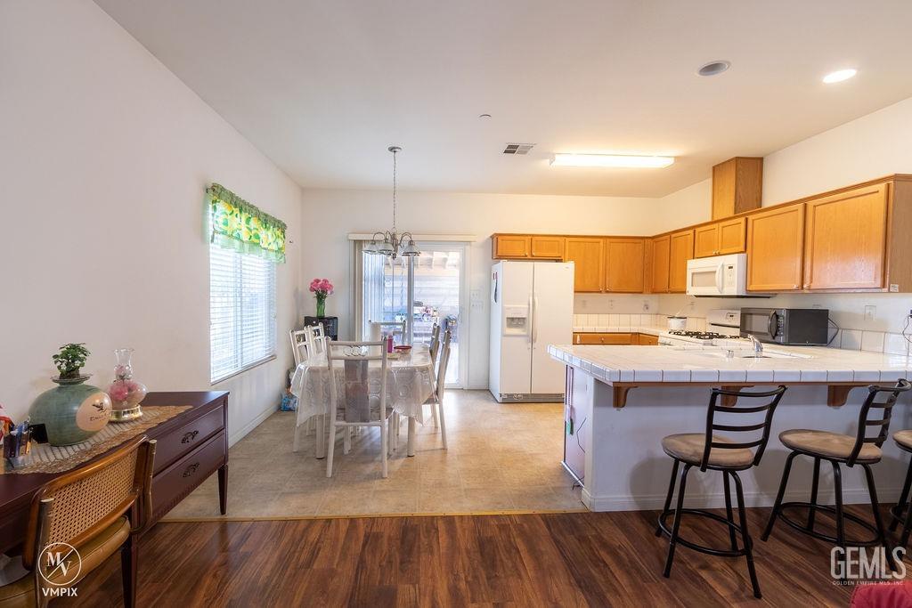 Undisclosed Address Delano, CA 93215 - Photo 5 of 23 a view of a dining room with furniture window and wooden floor