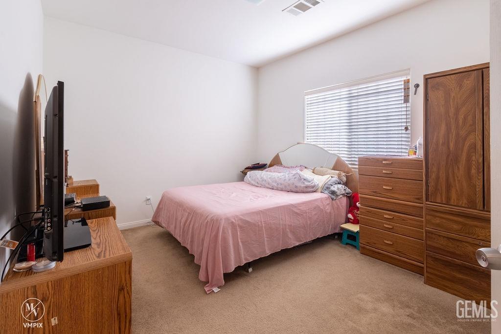 Undisclosed Address Delano, CA 93215 - Photo 7 of 23 a bedroom with a bed and flat screen tv