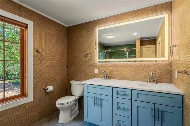 a bathroom with a sink a bathtub and a window