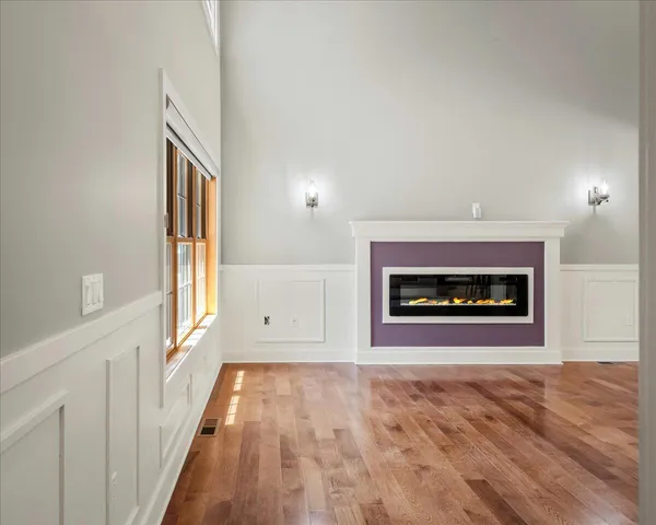 a view of a room with wooden floor and windows