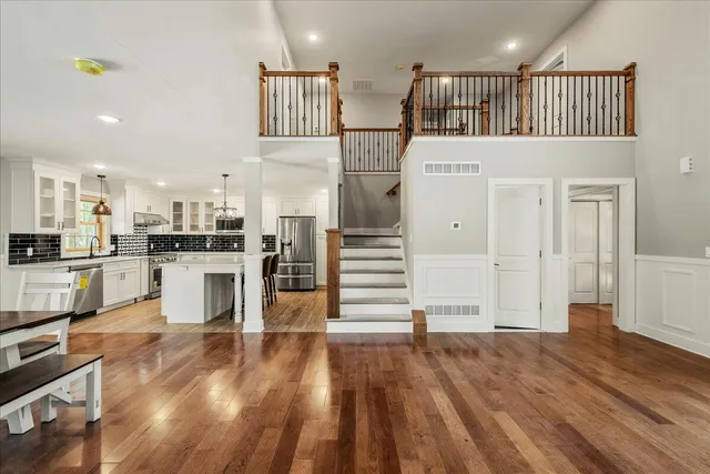 a view of a room with gym equipment and a chandelier
