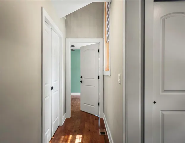 a bathroom with a glass shower door and a window