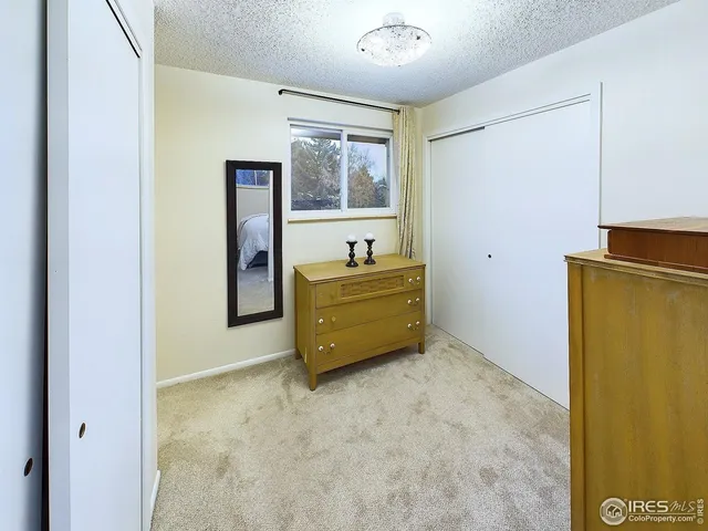 a room with a dresser and a window