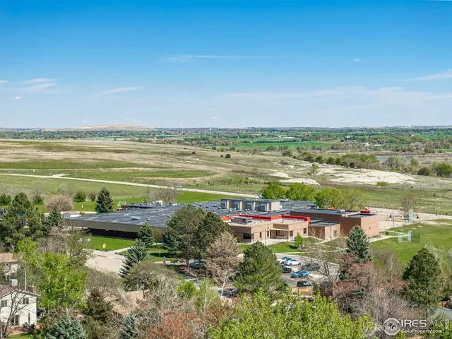 a view of a city with lots of residential buildings ocean and mountain view in back