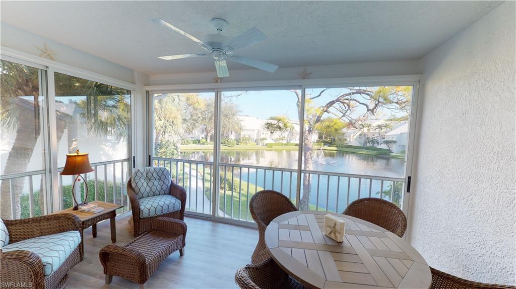 792 Willowbrook Drive, Unit 408 Naples, FL 34108 - Photo 1 of 7 a living room with furniture and a large window