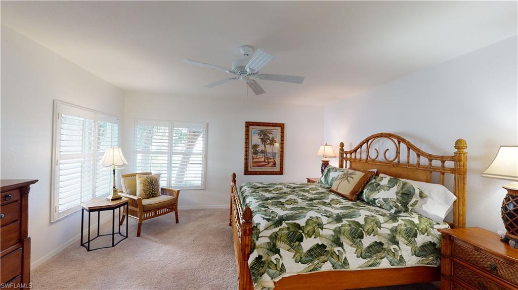 792 Willowbrook Drive, Unit 408 Naples, FL 34108 - Photo 4 of 7 a bedroom with a bed and chair with window