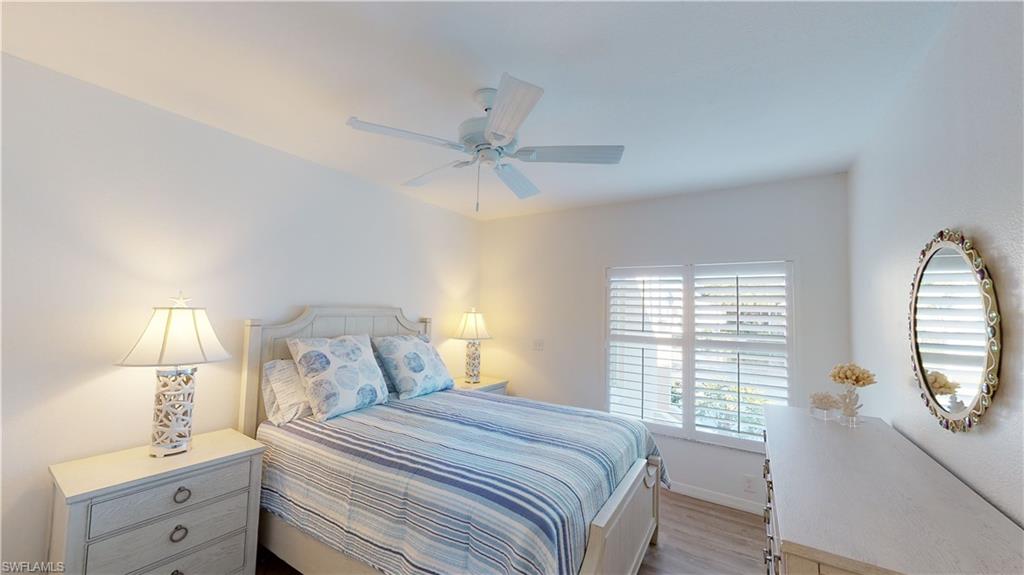 792 Willowbrook Drive, Unit 408 Naples, FL 34108 - Photo 6 of 7 a bedroom with a bed and a window