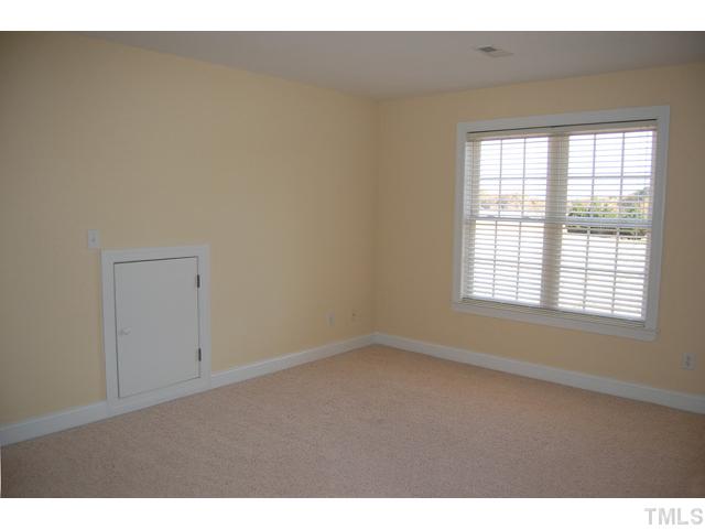 1600 Kendall Hill Road Willow Spring, NC 27592 - Photo 16 of 25 a view of an empty room with a window