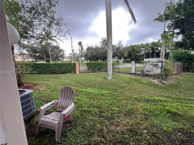 a view of a chair and table in the garden