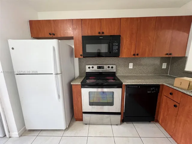 a kitchen with a refrigerator and a microwave