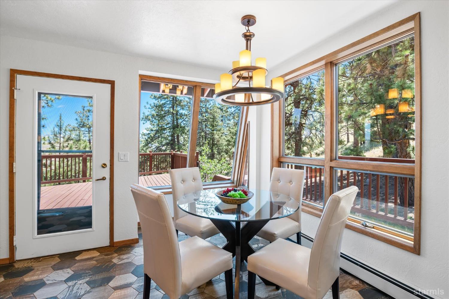 4201 Sandy Circle Carson City, NV 89703 - Photo 14 of 40 a view of a dining room with furniture a chandelier and wooden floor
