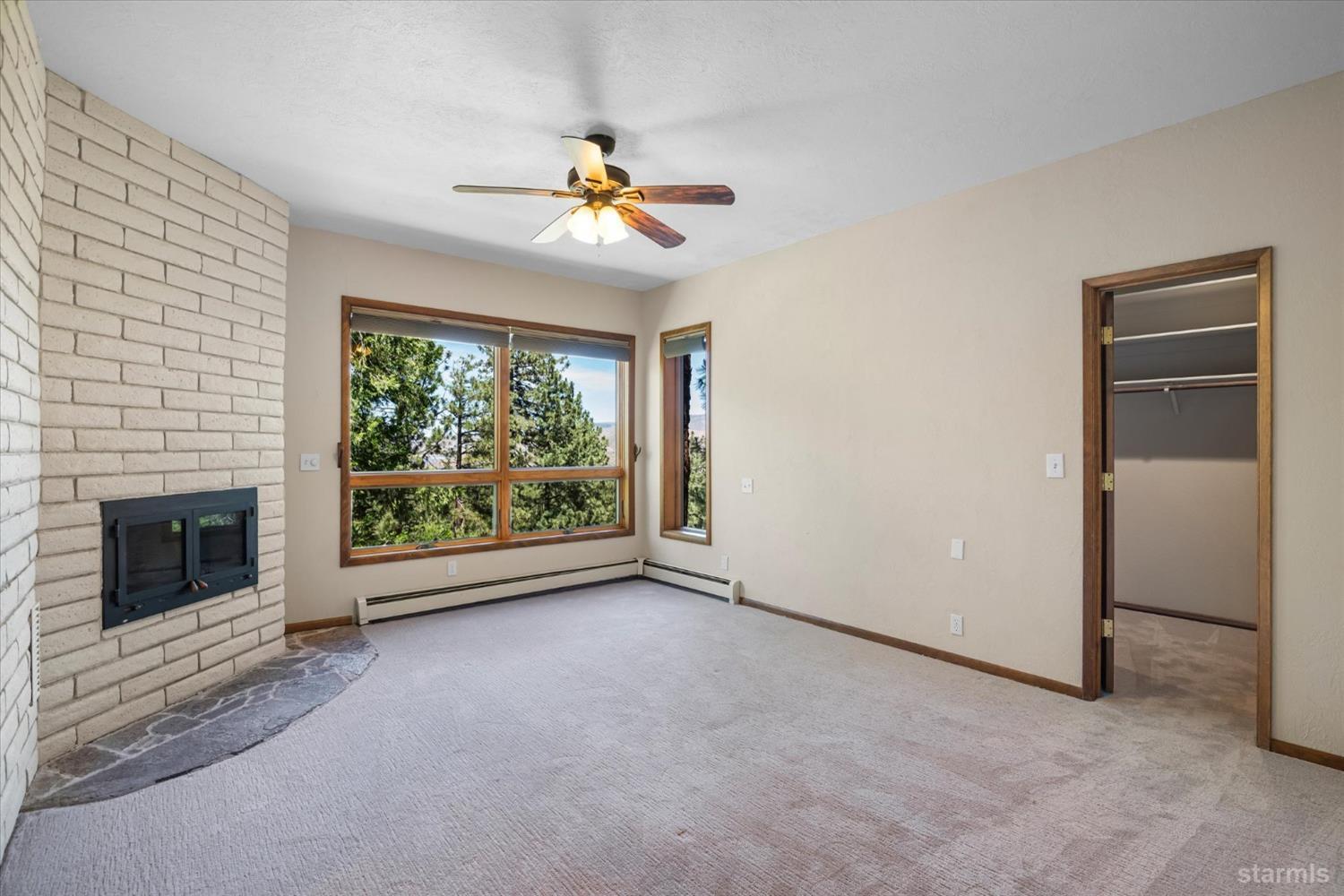 4201 Sandy Circle Carson City, NV 89703 - Photo 28 of 40 en empty room with windows fireplace and fan