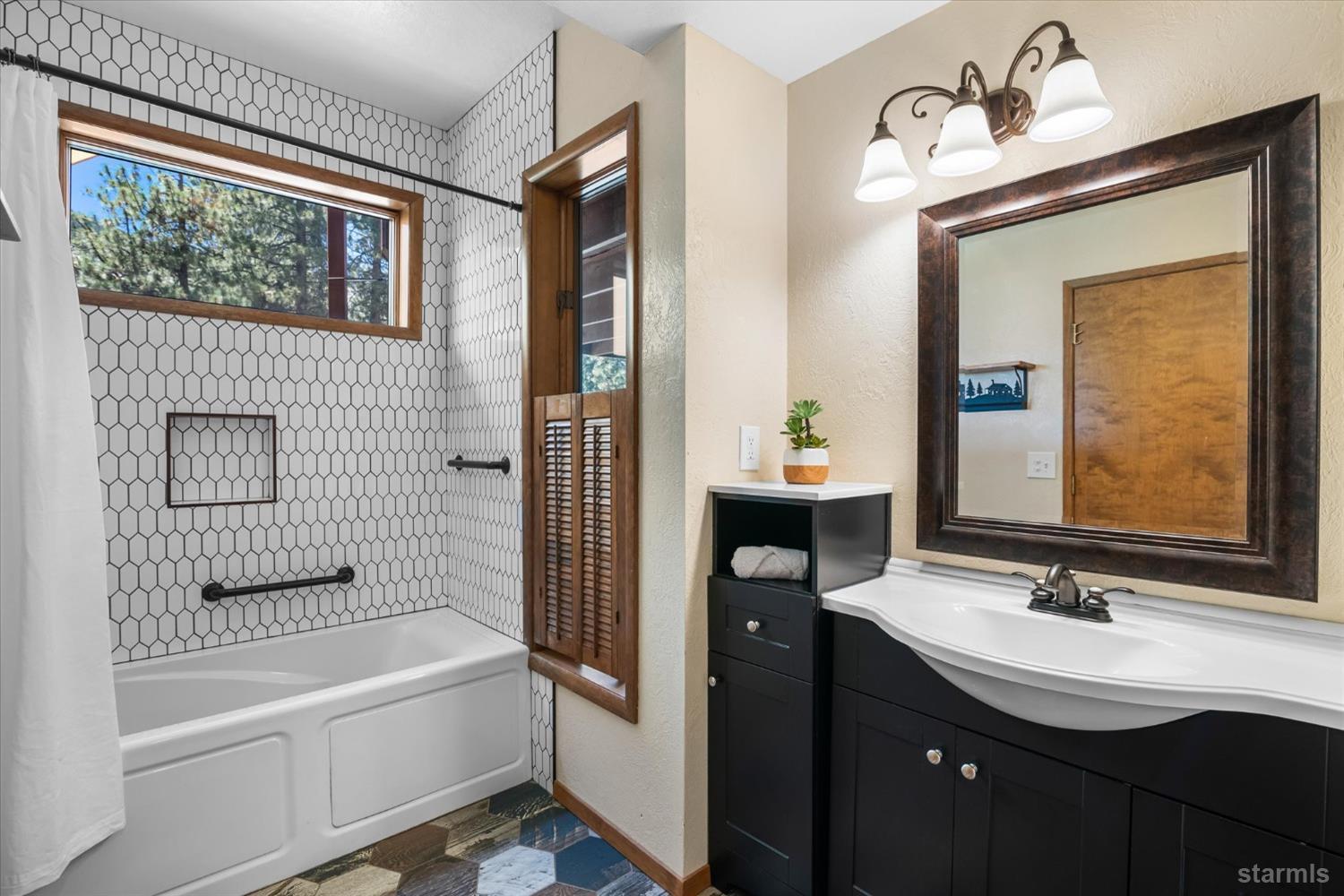 4201 Sandy Circle Carson City, NV 89703 - Photo 34 of 40 a bathroom with a sink a bathtub and a mirror