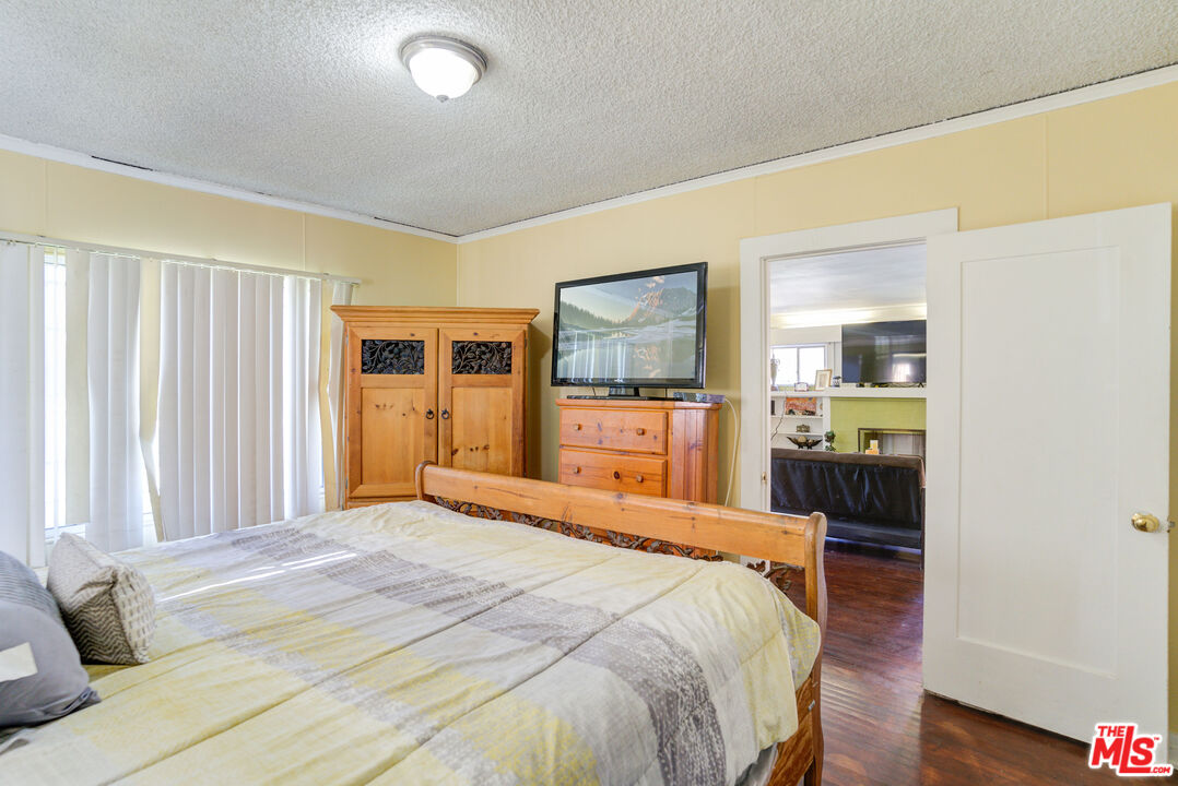 2404 Virginia Road Los Angeles, CA 90016 - Photo 6 of 21 a bedroom with a large bed and a dresser