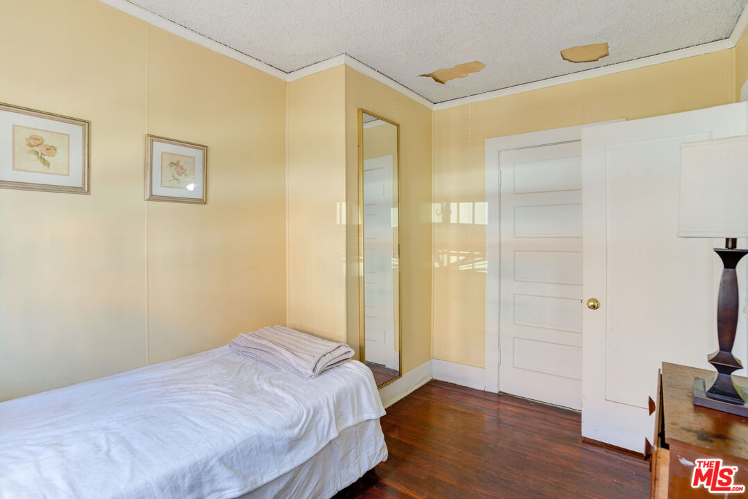 2404 Virginia Road Los Angeles, CA 90016 - Photo 9 of 21 a bedroom with a bed and wooden floor