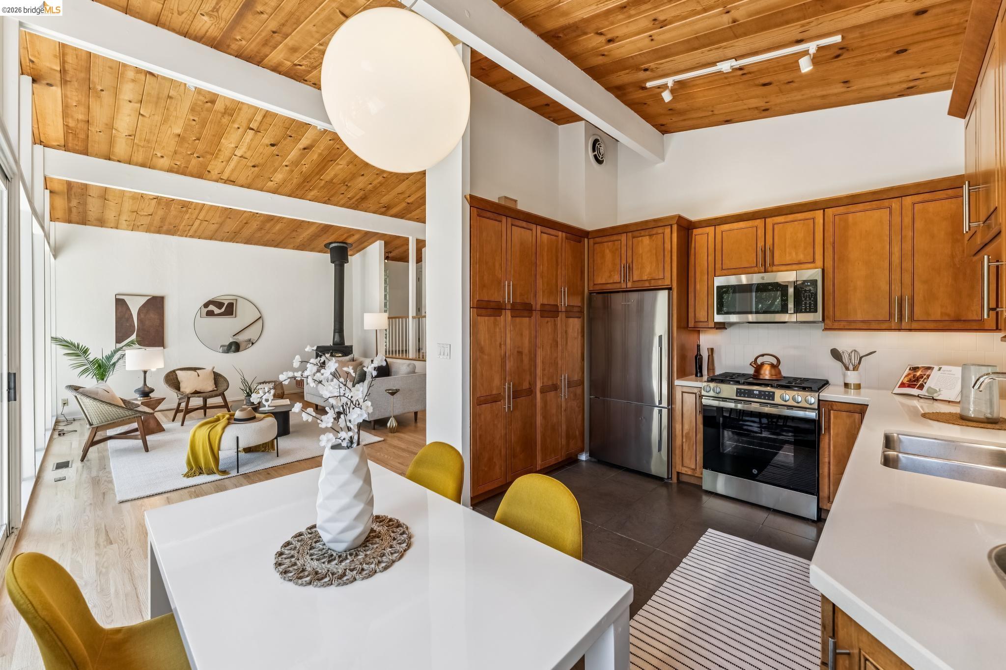 6645 Heather Ridge Way Oakland, CA 94611 - Photo 34 of 61 Open-concept kitchen and dining area featuring a wood-finish vaulted ceiling with exposed beams