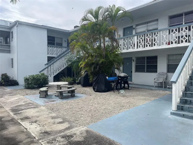 a view of a patio with table and chairs and potted plants