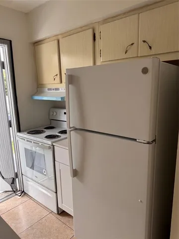 a white refrigerator freezer sitting inside of a kitchen