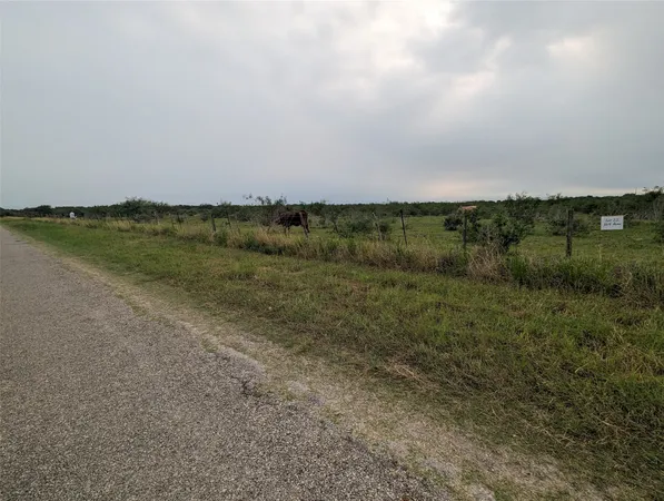 a view of a wooden fence and a yard