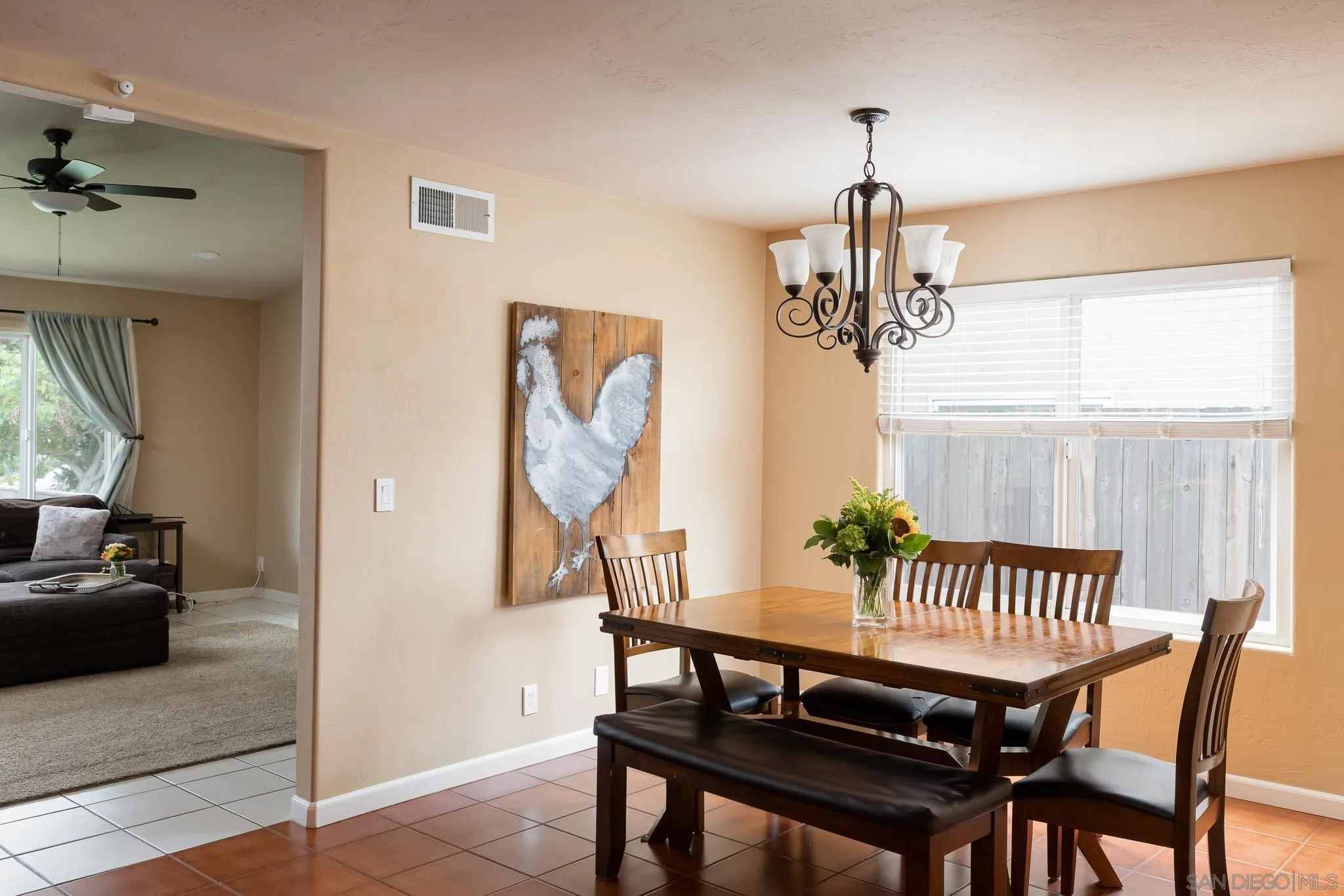 12822 Pinefield Road Poway, CA 92064 - Photo 8 of 23 a view of a dining room with furniture a chandelier and wooden floor