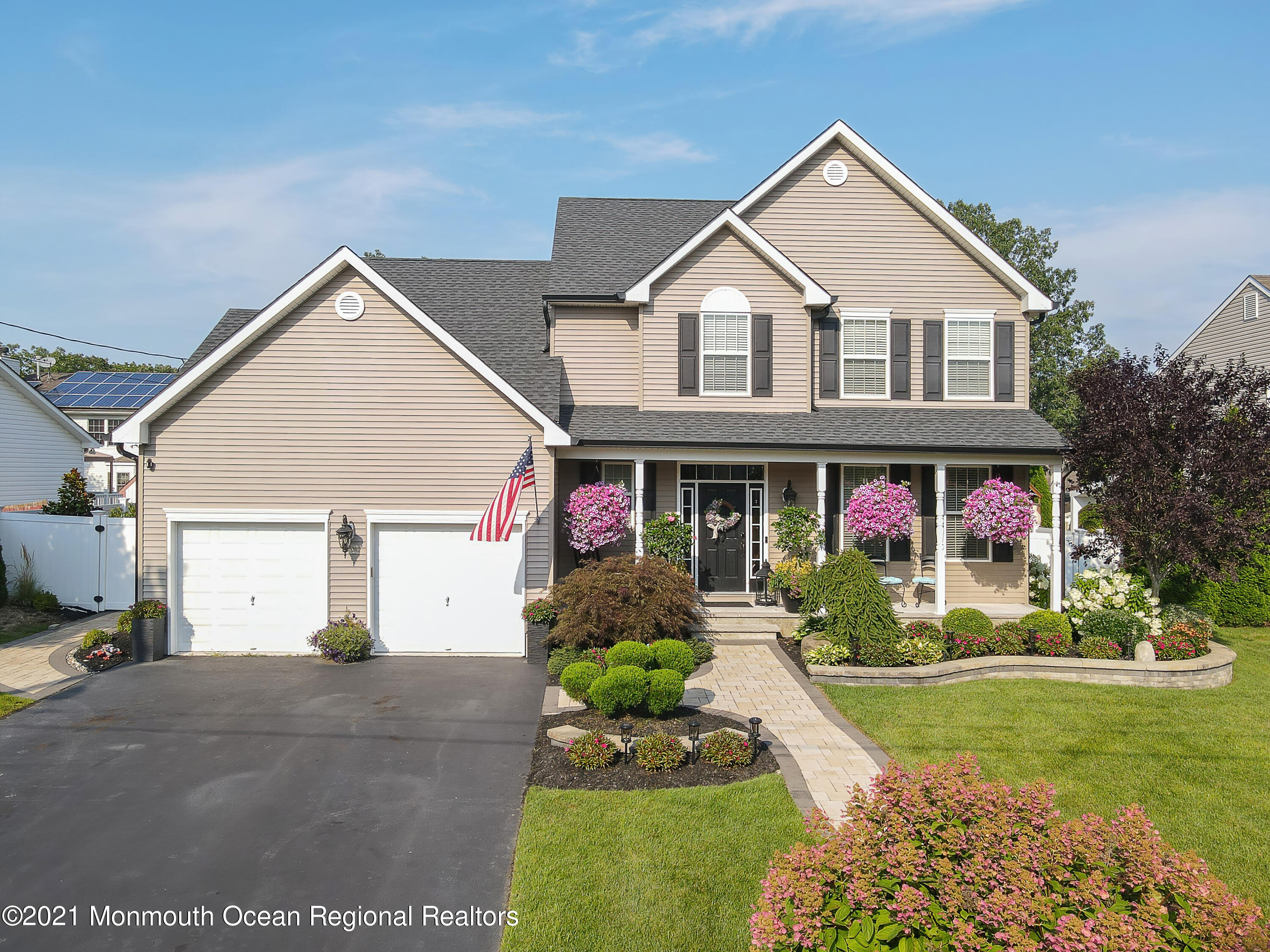 241 Privateer Road Manahawkin, NJ 08050 - Photo 12 of 44 a front view of a house with a yard and garage